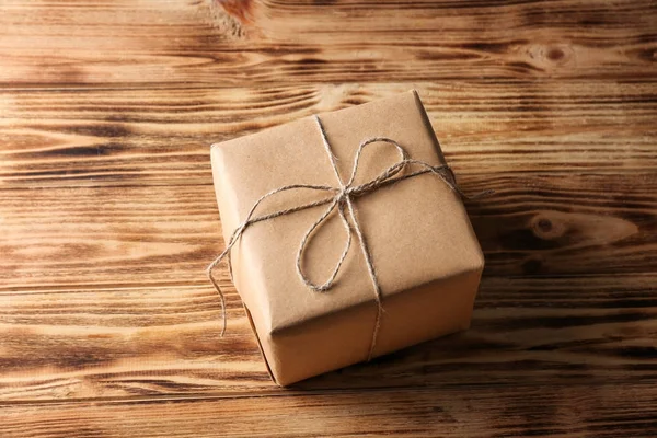 Parcel gift box on wooden background — Stock Photo, Image