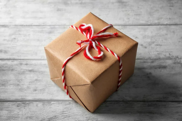 Parcel gift box on wooden background — Stock Photo, Image