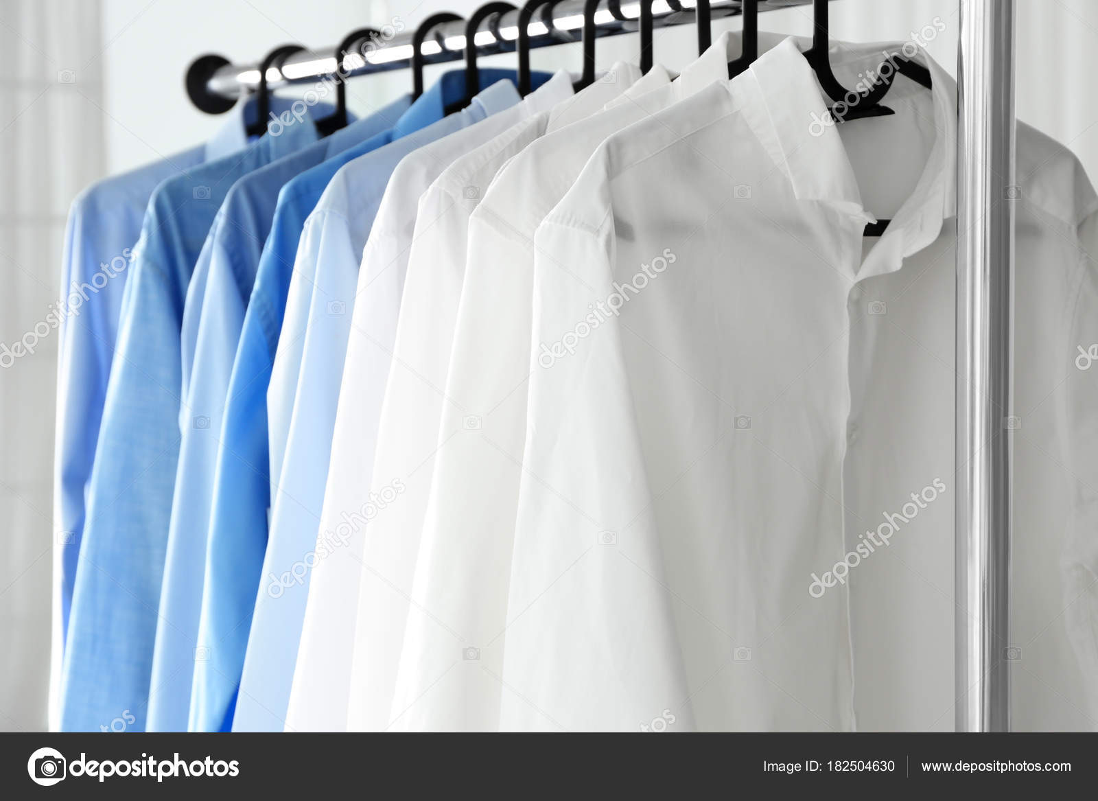 Rack with clean shirts in laundry — Stock Photo © belchonock #182504630