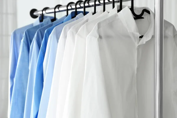 Rack with clean shirts in laundry — Stock Photo, Image