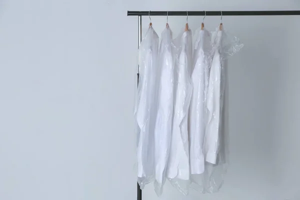 Rack with clean shirts in laundry — Stock Photo, Image