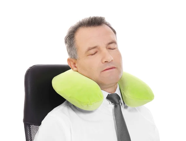 Mature businessman with travel pillow on white background — Stock Photo, Image