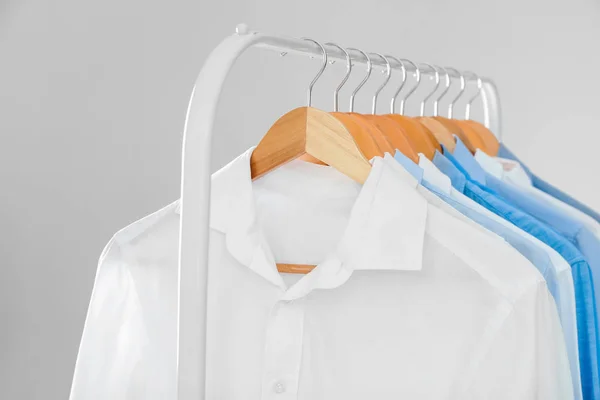 Rack with clean shirts in laundry — Stock Photo, Image