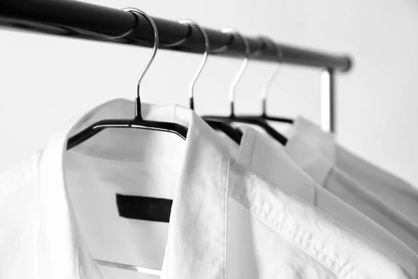 Hangers with clean shirts in laundry, closeup — Stock Photo, Image