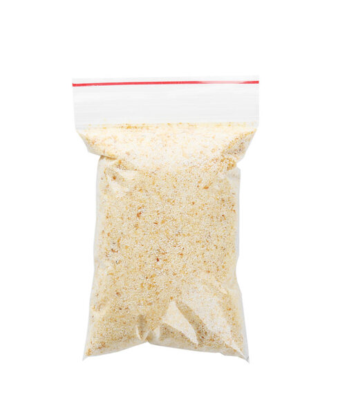 Ziploc bag with dried garlic powder on white background