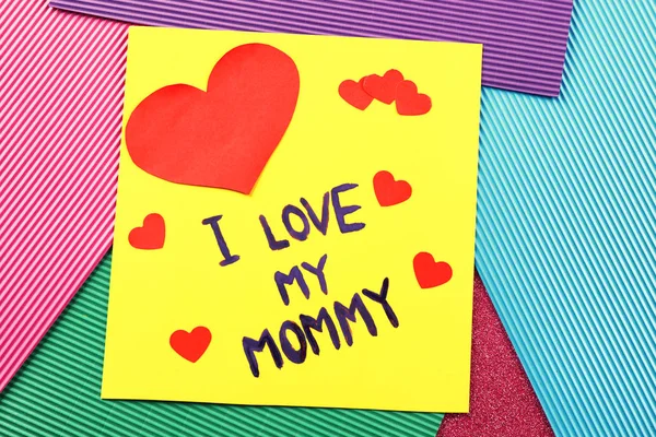 Cute handmade card with text I LOVE MY MOMMY on table. Mother's day celebration — Stock Photo, Image