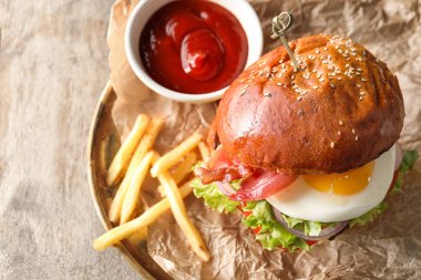 Plaka ile lezzetli hamburger ve patates kızartması ahşap tablo