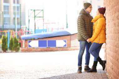 Seven genç çift tuğla duvar açık havada yakınındaki mutlu