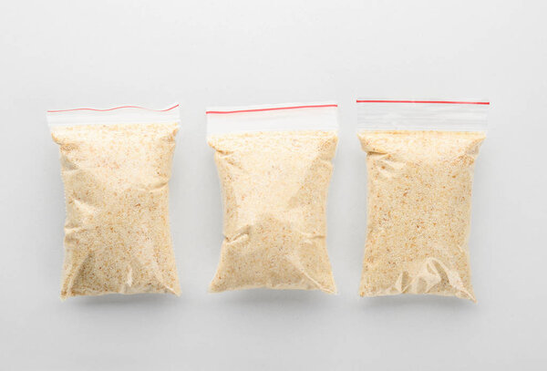 Ziploc bags with dried garlic powder on white background