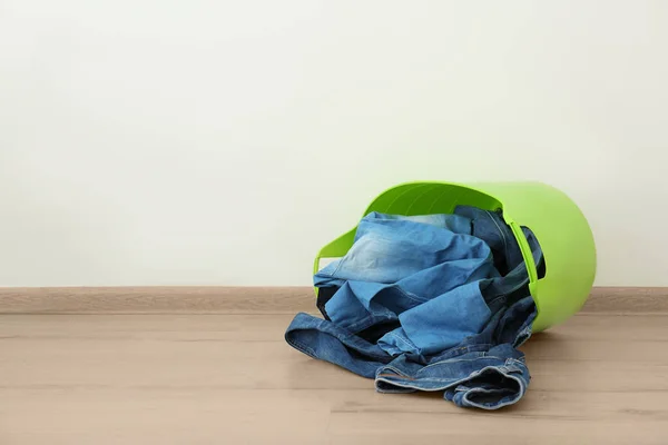 Basket with dirty clothes prepared for laundry indoors — Stock Photo, Image