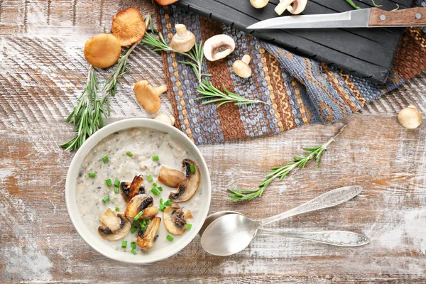 Mangkuk dengan sup jamur lezat di atas meja kayu — Stok Foto