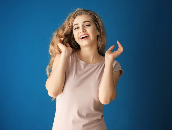 Portrait of beautiful laughing woman on color background — Stock Photo, Image