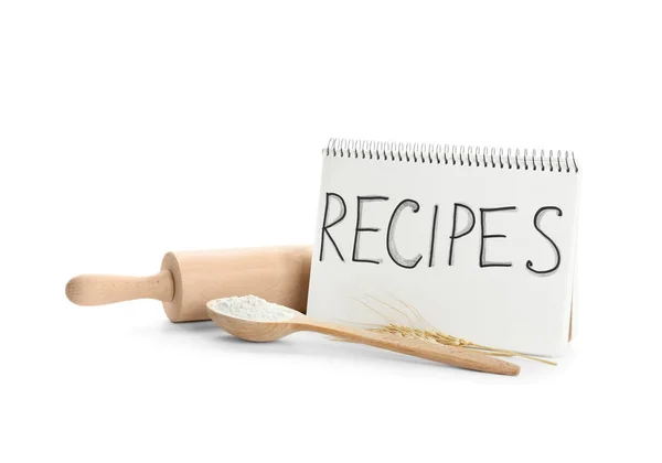 Flour for bread, kitchen utensils and notebook on white background — Stock Photo, Image