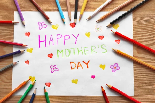 Handmade card with text HAPPY MOTHER'S DAY and pencils on wooden table — Stock Photo, Image