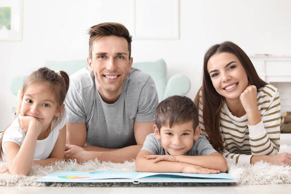 Happy family reading book at home
