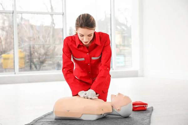 Young Woman Practicing First Aid Mannequin Indoors — Stock Photo, Image
