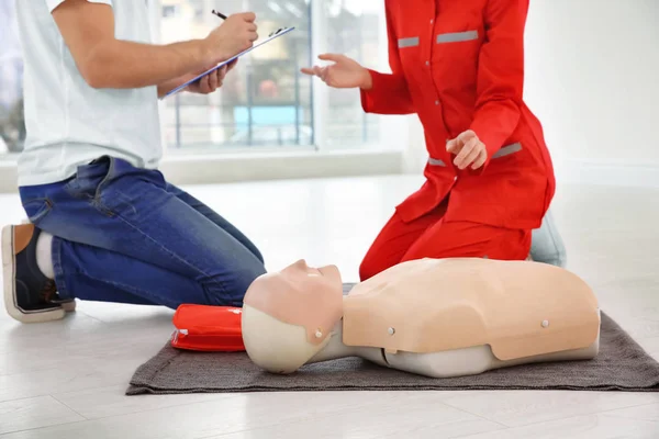 First aid mannequin on floor indoors. Life saving class