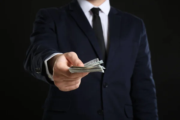 Businessman Holding Bribe Black Background — Stock Photo, Image