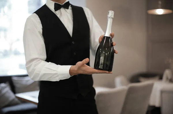 Waiter Holding Bottle Champagne Indoors Closeup — Stock Photo, Image