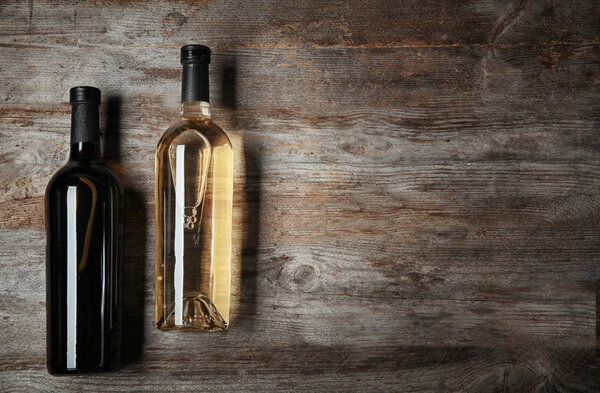 Bottles of wine on wooden background