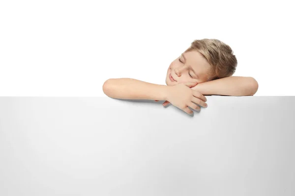 Sleeping boy with blank advertising board on white background — Stock Photo, Image