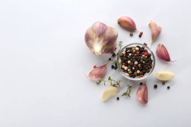 Taze sarımsak ve biber taneleri beyaz arka planda, üstten görünüm