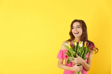 Lale buketi renk arka plan üzerinde tutan güzel kadın