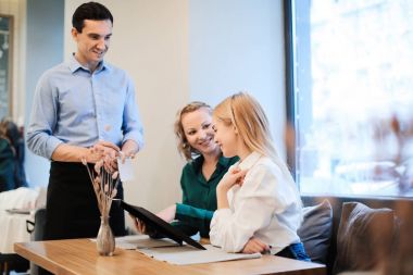 Genç garson kafede emir alan