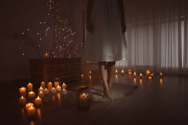 Woman Standing Burning Candles Floor Home — Stock Photo, Image