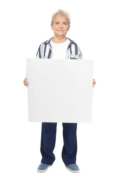 Senior woman with blank advertising board on white background — Stock Photo, Image