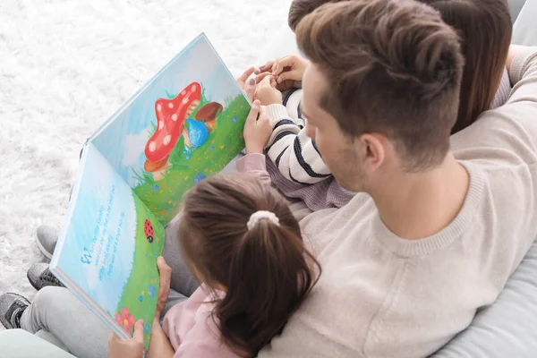 Young Family Reading Book Home — Stock Photo, Image