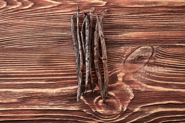 Vanilla sticks on wooden background