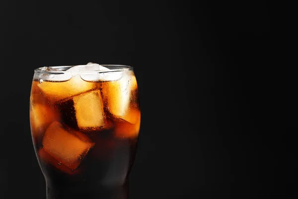 Glass of refreshing cola with ice on black background, closeup — Stock Photo, Image