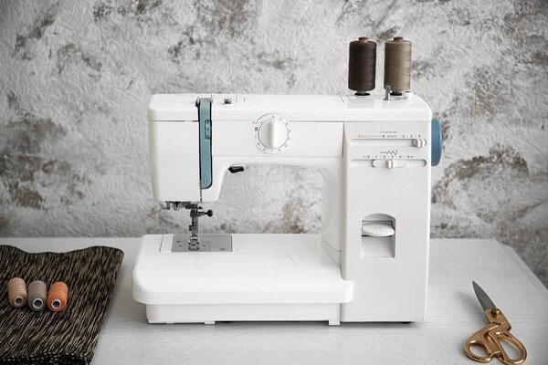 Sewing machine on table in tailor's workshop