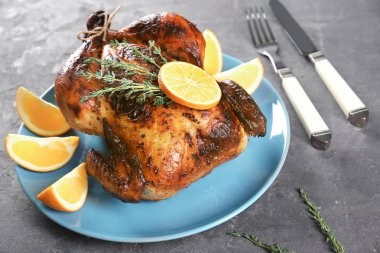 Tabakta portakal ile lezzetli bütün kavrulmuş tavuk