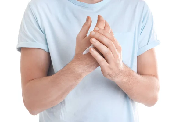 Man applying hand cream on white background, closeup — Stock Photo, Image