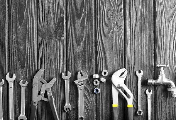 Plumber\'s tools on wooden background
