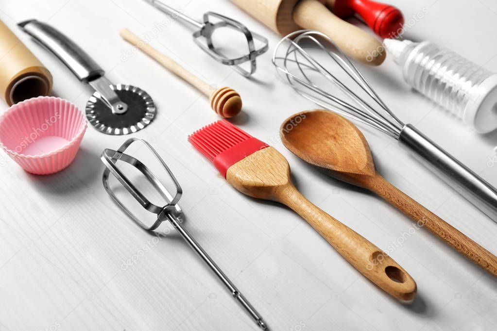 Kitchen utensils for preparing pastries on wooden background
