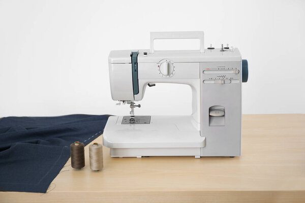 Sewing machine on table in tailor's workshop