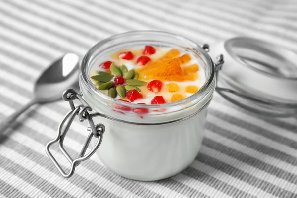 Joghurt mit Dattelpflaume, Granatapfel und Kürbiskernen im Glas auf Stoff — Stockfoto