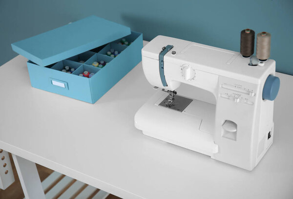 Sewing machine on table in tailor's workshop