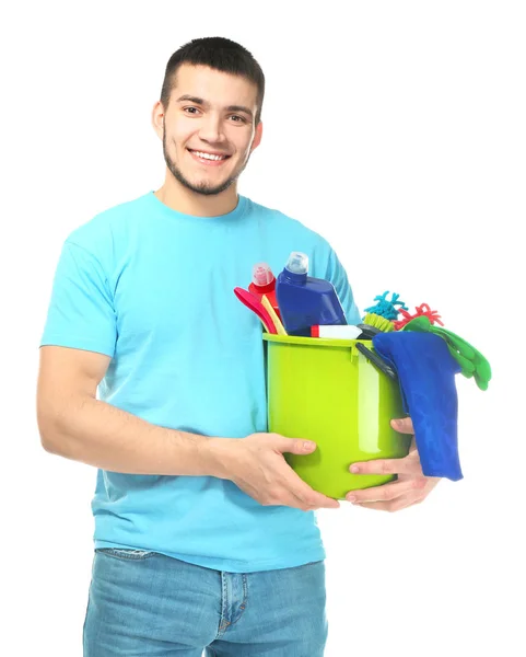 Young man with cleaning supplies on white background — Stock Photo, Image