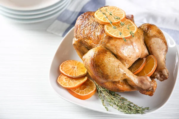 Delicioso pollo asado entero con naranja servido en el plato —  Fotos de Stock