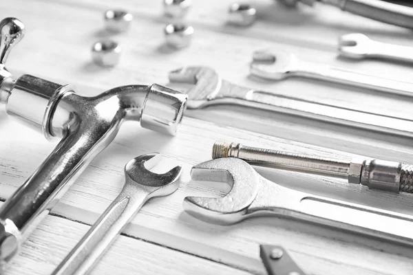 Plumber\'s tools on wooden background