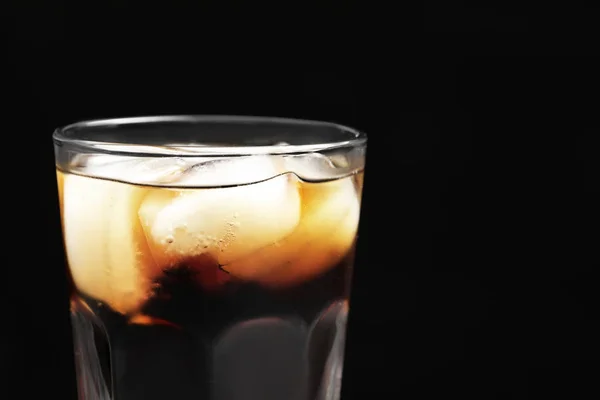 Glass of refreshing cola with ice on black background, closeup — Stock Photo, Image