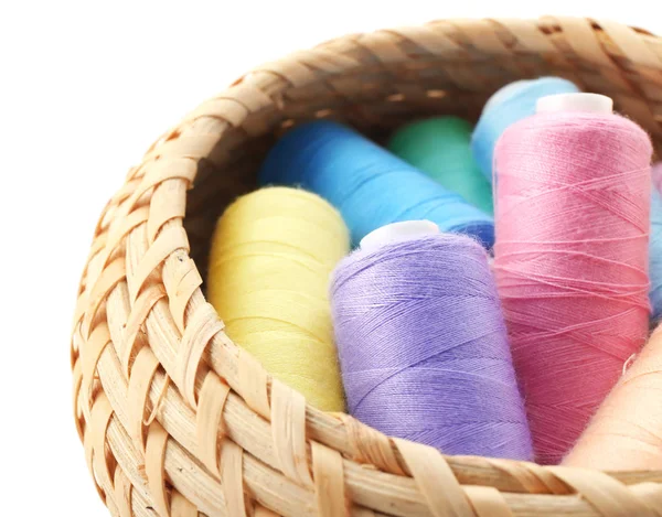 Wicker basket with colorful sewing threads — Stock Photo, Image