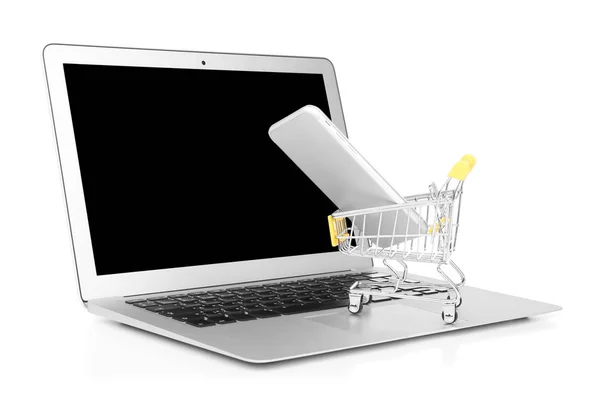 Laptop e piccolo carrello con cellulare su sfondo bianco. Internet shopping concept — Foto Stock