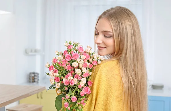 自宅のバラの花束と美しい若い女性 — ストック写真
