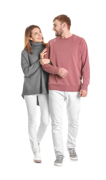 Young couple in casual clothes walking on white background — Stock Photo, Image