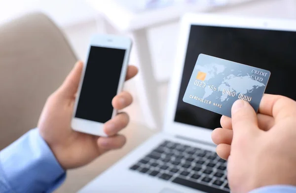 Man with credit card and mobile phone, closeup — Stock Photo, Image